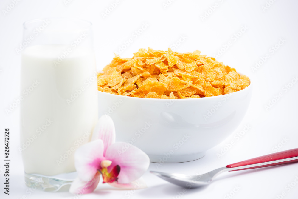 Natural corn flake breakfast cereal in cups and milk is a healthy breakfast that is good for your body every day on a white background. Natural corn flake breakfast cereal in cups and milk is a healthy breakfast that is good for your body every day on a white background.