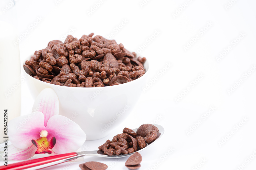 Breakfast cereal, cornflake chocolate in cups and milk is a healthy breakfast that is healthy for the body every day on a white background. Breakfast cereal, cornflake chocolate in cups and milk is a healthy breakfast that is healthy for the body every day on a white background.