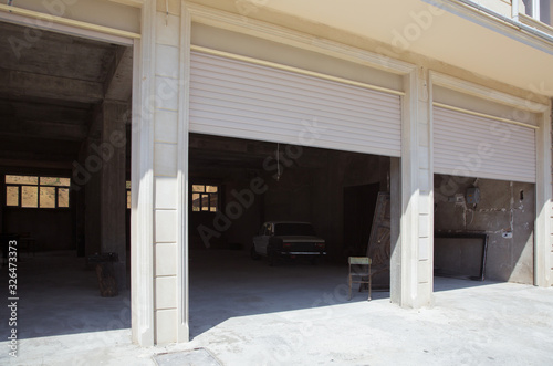Wallpaper Mural Shutter door or roller door and concrete floor outside .White Automatic shutters in a house . gates in the garage . Automatic Electric Roll-up Gate Or Push-up Door In The Modern Building  . Torontodigital.ca