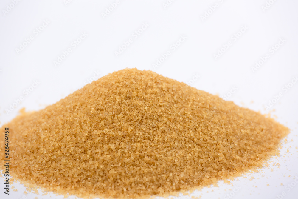 Brown sugar on a white background, healthy sugar used for cooking or desserts. Brown sugar on a white background, healthy sugar used for cooking or desserts.