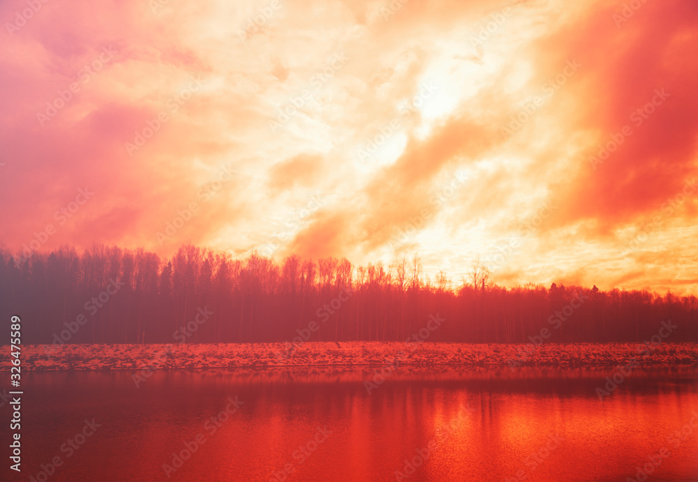 Burning sunset on winter river background