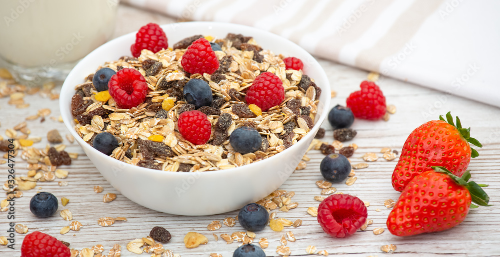 Breakfast Served in the morning with corn flakes Whole grains and raisins with milk in cups and Strawberry, Blueberry, Raspberry, Kiwi on the wood table,Diet food or healthy food in the morning. Breakfast Served in the morning with corn flakes Whole grains and raisins with milk in cups and Strawberry, Blueberry, Raspberry, Kiwi on the wood table,Diet food or healthy food in the morning.