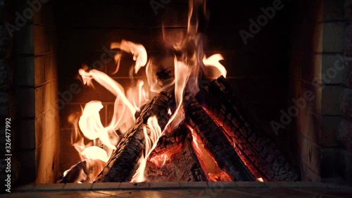 Burning fire in the fireplace in country house. 4K video, slow motion.