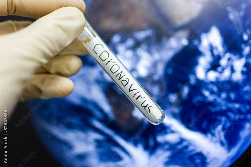 Obraz premium coronavirus epidemic in the world. Test tube on the background of the planet.