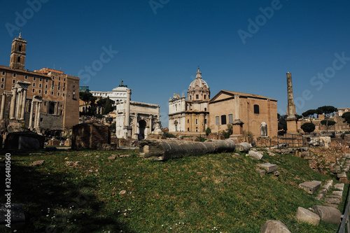 Daytime panoramic sunny photo of the ancient ruins of the Roman Forum. Scenic view on Foro Romano in Rome.