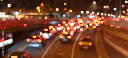 Traffic in the city at night. Bright blurred lights.