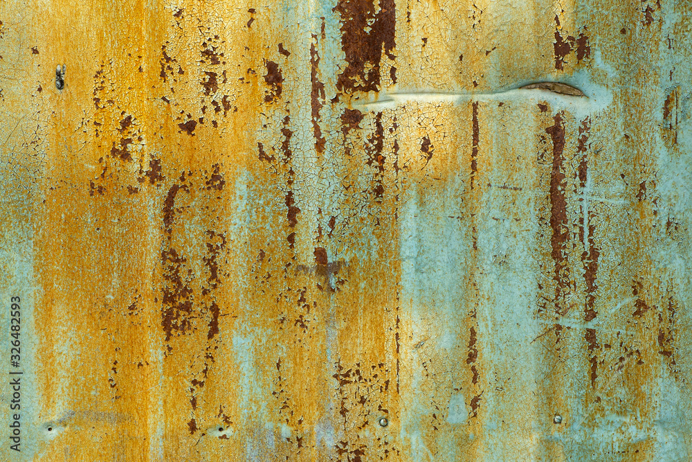 Old metal background. Texture of the old dried green yellow paint on a rusty metal surface