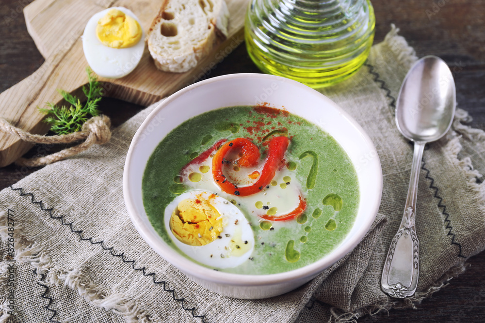 Green pea soup with spinach. Olive oil, red grilled bell pepper and half boiled egg dressing