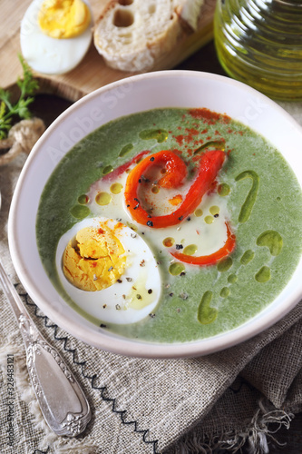 Green pea soup with spinach. Olive oil, red grilled bell pepper and half boiled egg dressing