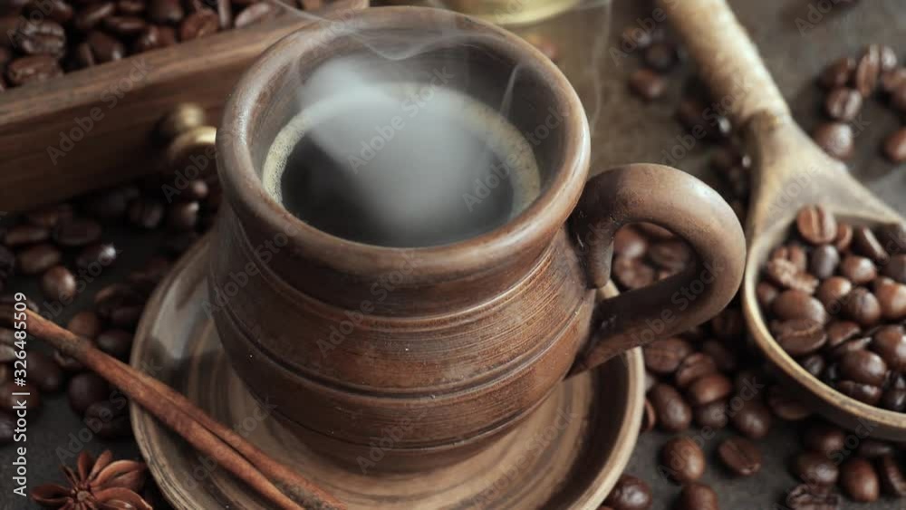 Roasted coffee beans with smoke in a frying pan. Roasted coffee beans with smoke in a frying pan.