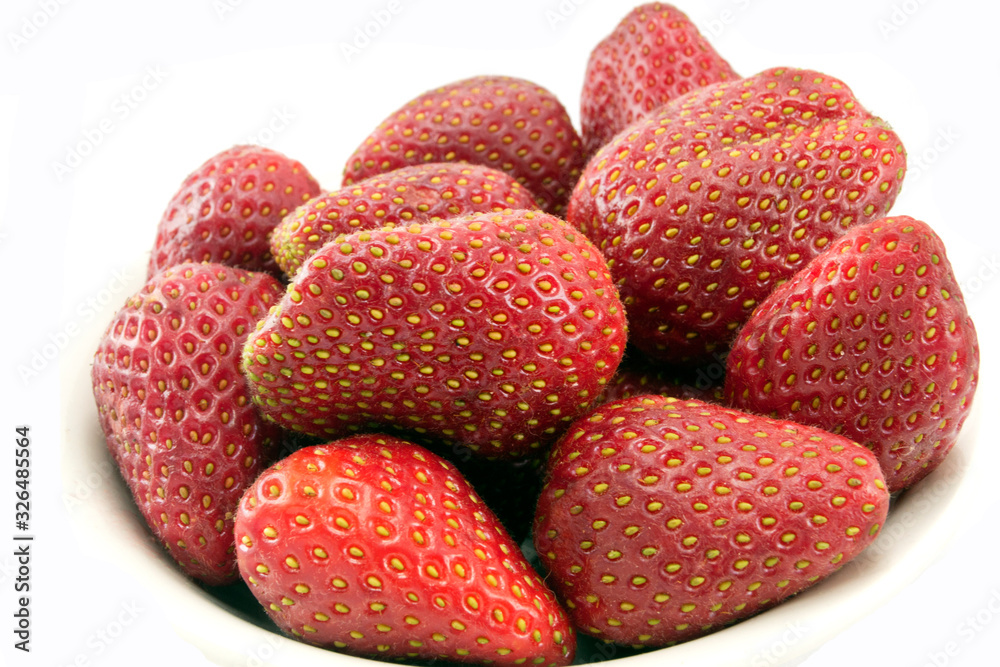 red strawberry berries in a plate on a white background red strawberry berries in a plate on a white background