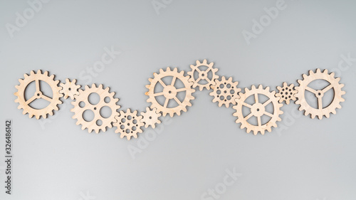A set of gears made of natural wood puzzle. Stacked into a single mechanism