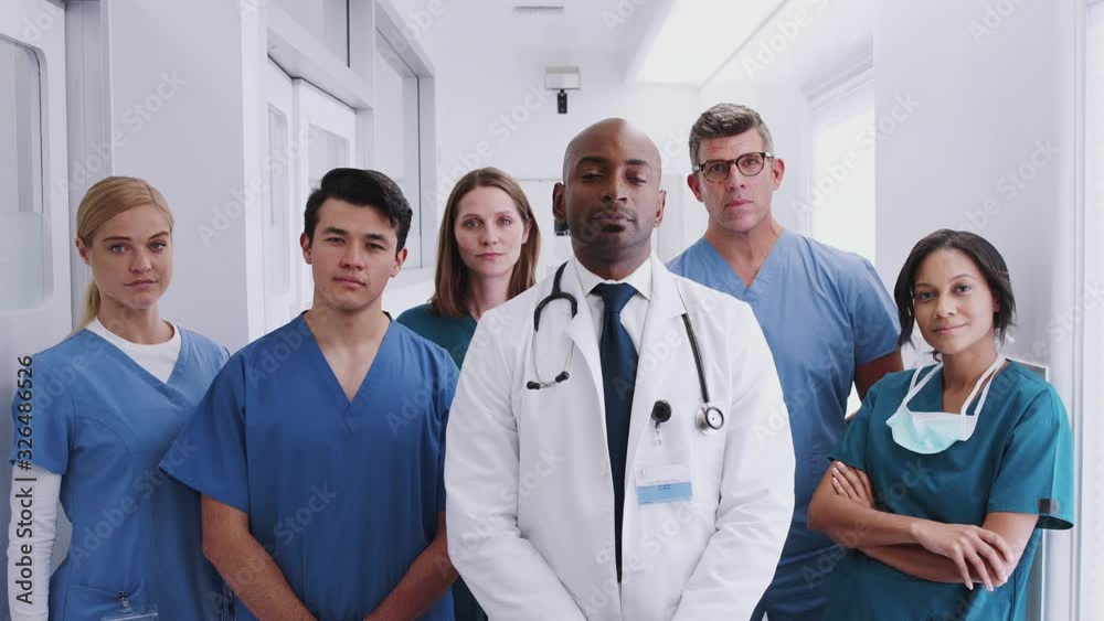 Portrait Of Multi-Cultural Medical Team Standing In Hospital Corridor Portrait Of Multi-Cultural Medical Team Standing In Hospital Corridor