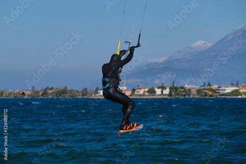 kitesurfer in the jump on a background of high mountains