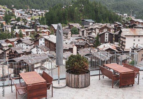 Swiss Alps. Outdoor terrace overlooking Zermatt. Wooden benches and outdoor tables. Cafe or hotel terrace photo