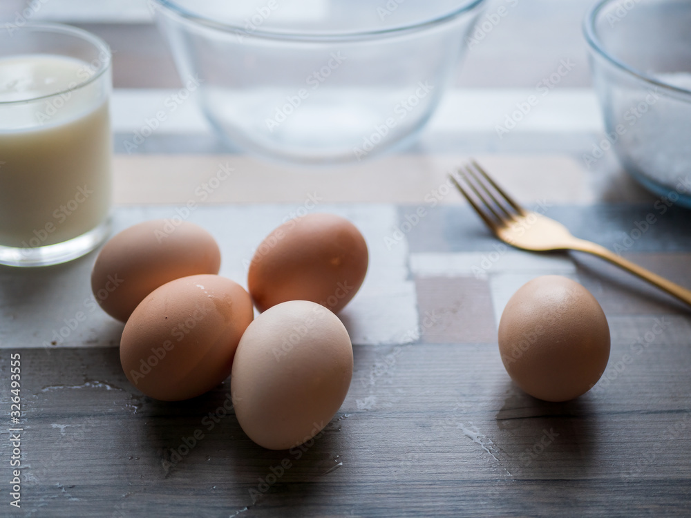 process of making omelet from natural eggs and products. Milk, salt, eggs. Cup for whipping omelet. Fork and knife. Frying pan and oil process of making omelet from natural eggs and products. Milk, salt, eggs. Cup for whipping omelet. Fork and knife. Frying pan and oil
