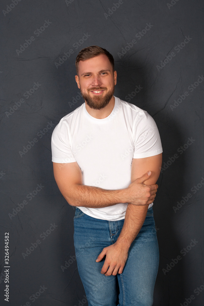 Portrait of a man who is smiling, beautiful, inflated, on a gray background, with copy space. The concept of good mood and positive attitude. Portrait of a man who is smiling, beautiful, inflated, on a gray background, with copy space. The concept of good mood and positive attitude.