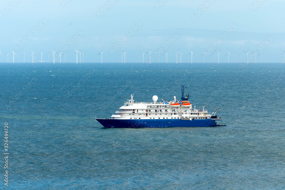 Blue cruise ship at sea. Passenger vessel. 