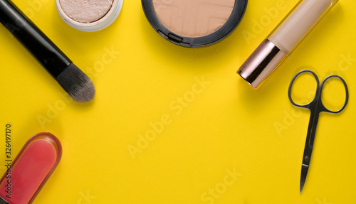 cosmetics on yellow background for women's or mother's day