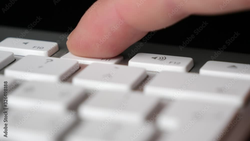 Pressing repeatedly the Volume Down (F11) button on keyboard. Close-up Pressing repeatedly the Volume Down (F11) button on keyboard. Close-up