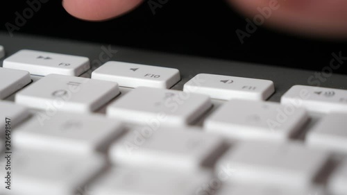 Pressing repeatedly the Mute (F10) button on keyboard. Close-up photo