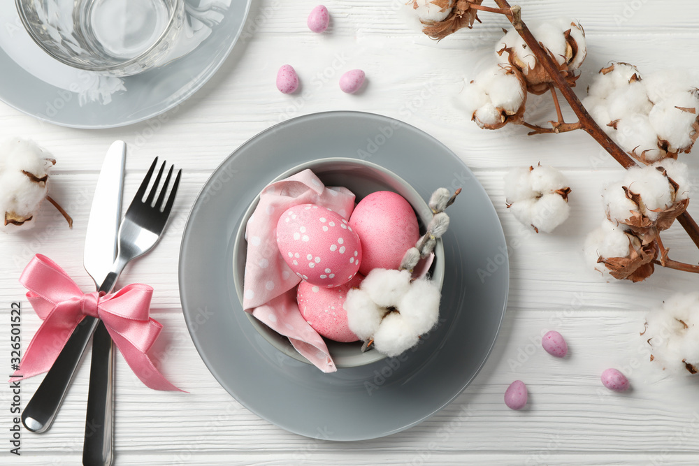 Easter table setting on white wood background, top view Easter table setting on white wood background, top view