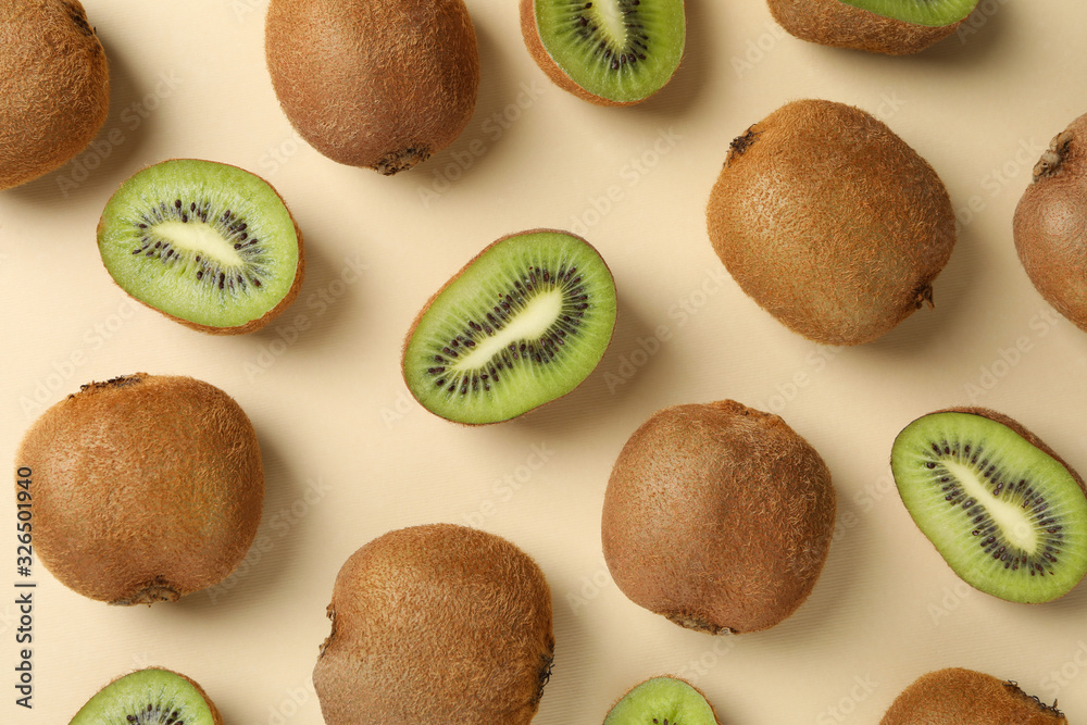 Fototapeta premium Ripe sweet kiwi on beige background, top view