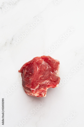Meat, beef, slices beef loin on a white background. Raw meat. Advertising for meat shop and farm. Various kinds of meat and ready to cook concept. Top view. Space for text