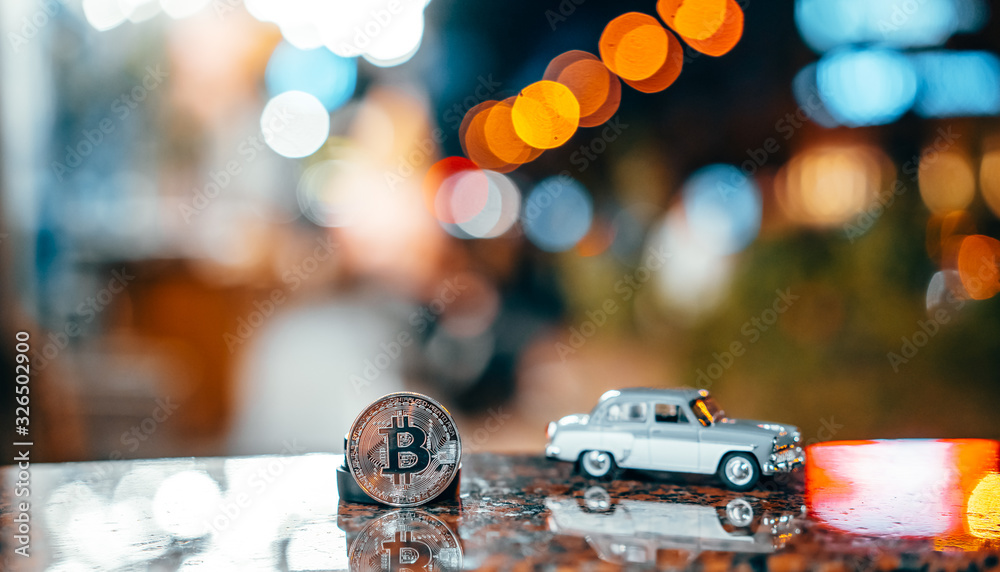 Silver bitcoin and Moskvich 401 on the table, glowing background