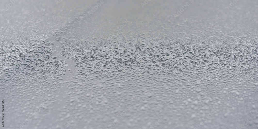 Raindrops on the hood of the car. Close-up. Raindrops on the hood of the car. Close-up.