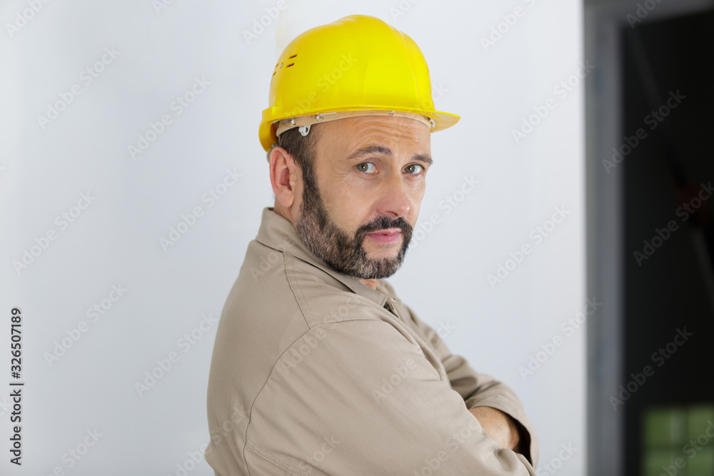 mature builder turning to look over his shoulder mature builder turning to look over his shoulder