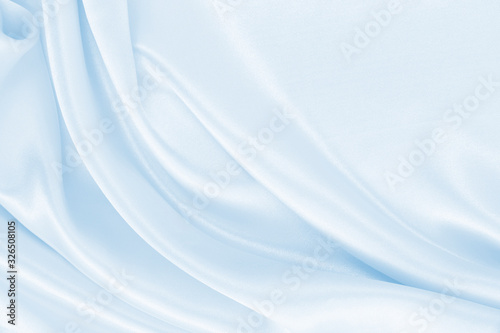 Smooth elegant blue silk or satin luxury cloth texture as abstract background. Luxurious background design