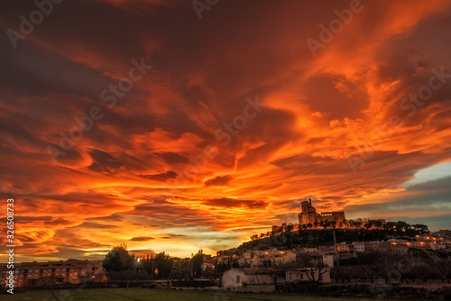 Spectacular sunset with lenticular clouds above a medieval castle in Caravaca de la Cruz, province of Murcia. Spain photo