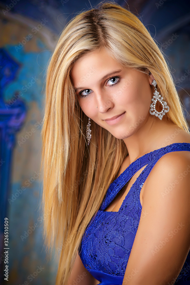 Naklejka premium Blond Hair Blue Dress Woman in a Studio