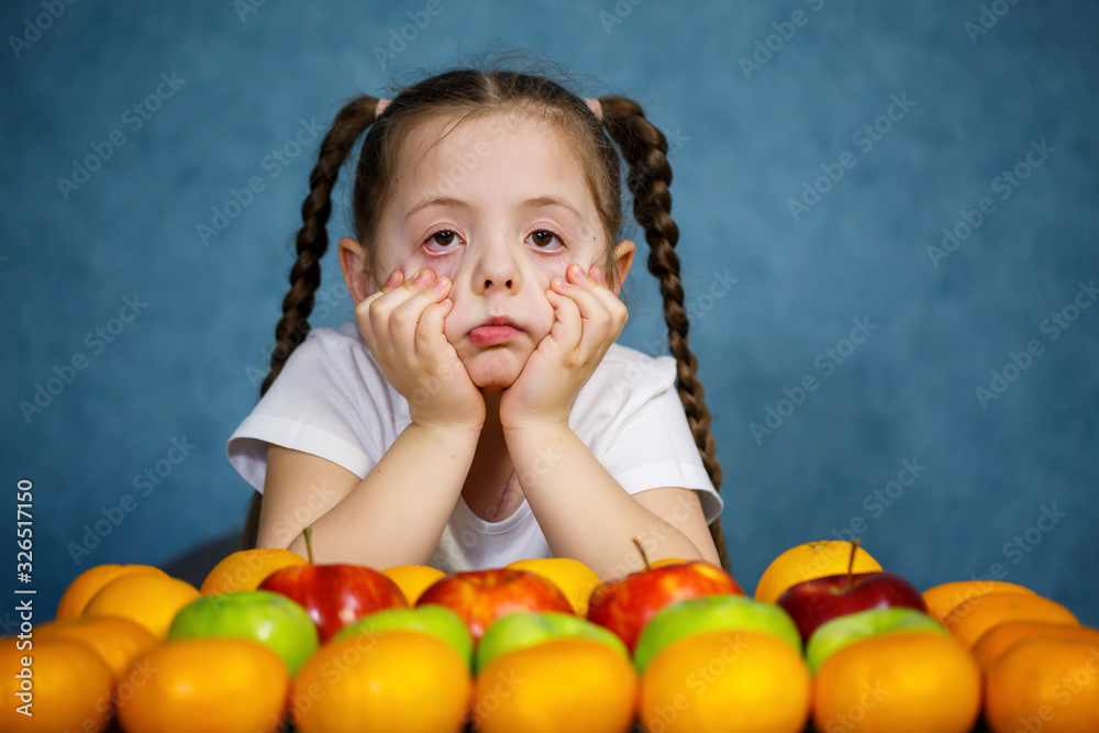 Little girl in white T-shirt love fruit