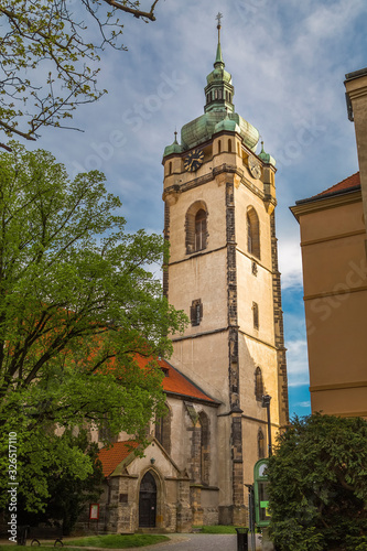 Wallpaper Mural old city street at sunset with high clock tower of the Church of Saints Peter and Paul Torontodigital.ca