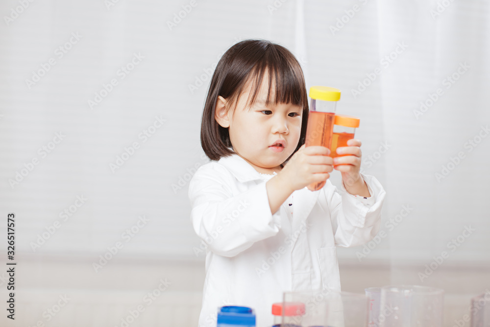 toddler girl pretend play scientist role at home against white background toddler girl pretend play scientist role at home against white background
