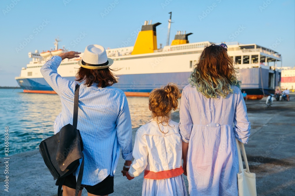 Family vacation together, mother and two daughters in seaport near ferry