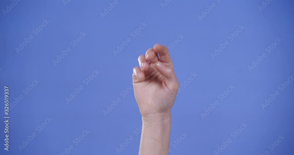 Woman showing N letter on blue background, closeup. Sign language Woman showing N letter on blue background, closeup. Sign language