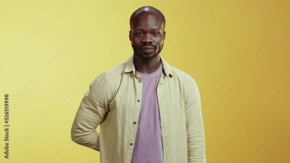 African cheerful generous young man offers a present cute red gift box smile positive celebrating holidays. Valentine's Day. Surprise concept. African cheerful generous young man offers a present cute red gift box smile positive celebrating holidays. Valentine's Day. Surprise concept.