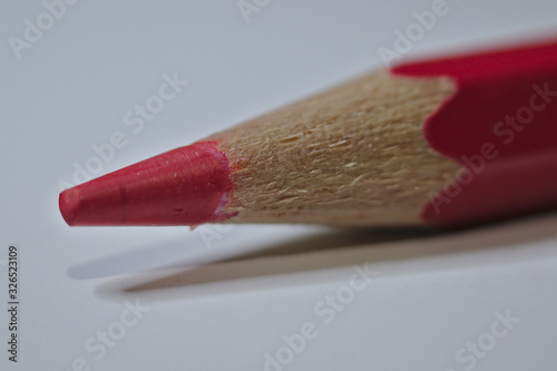 Red pencil sitting on white desk