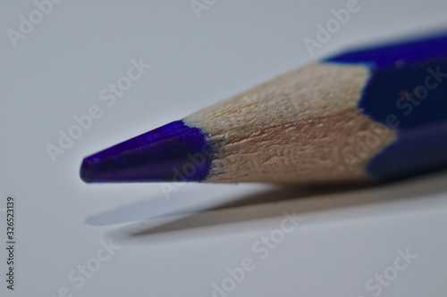 Blue pencil sitting on white desk