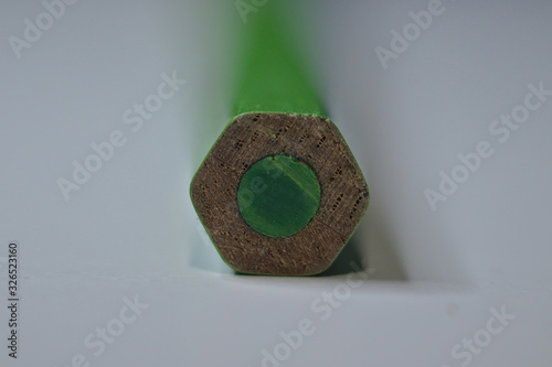 Green pencil sitting on white desk