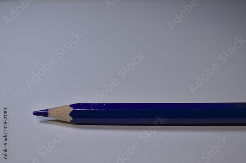 Blue pencil sitting on white desk