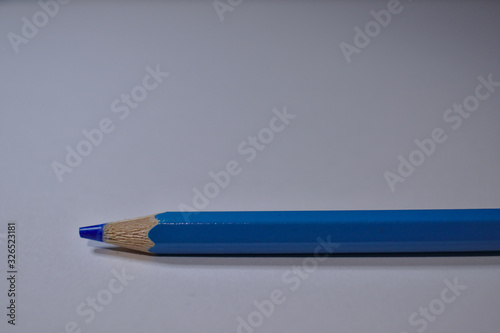 Blue pencil sitting on white desk
