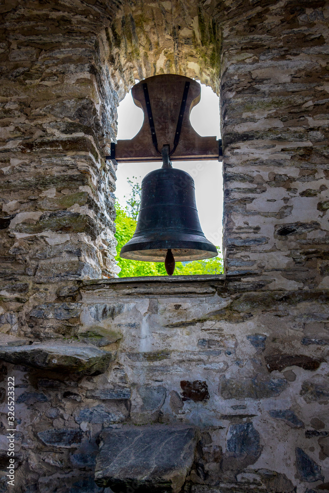 Obraz premium Bell in the bell tower of Church of San Juan at Hospital da Condesa in Province of Lugo, Galicia, Spain on the Way of St. James, Camino de Santiago