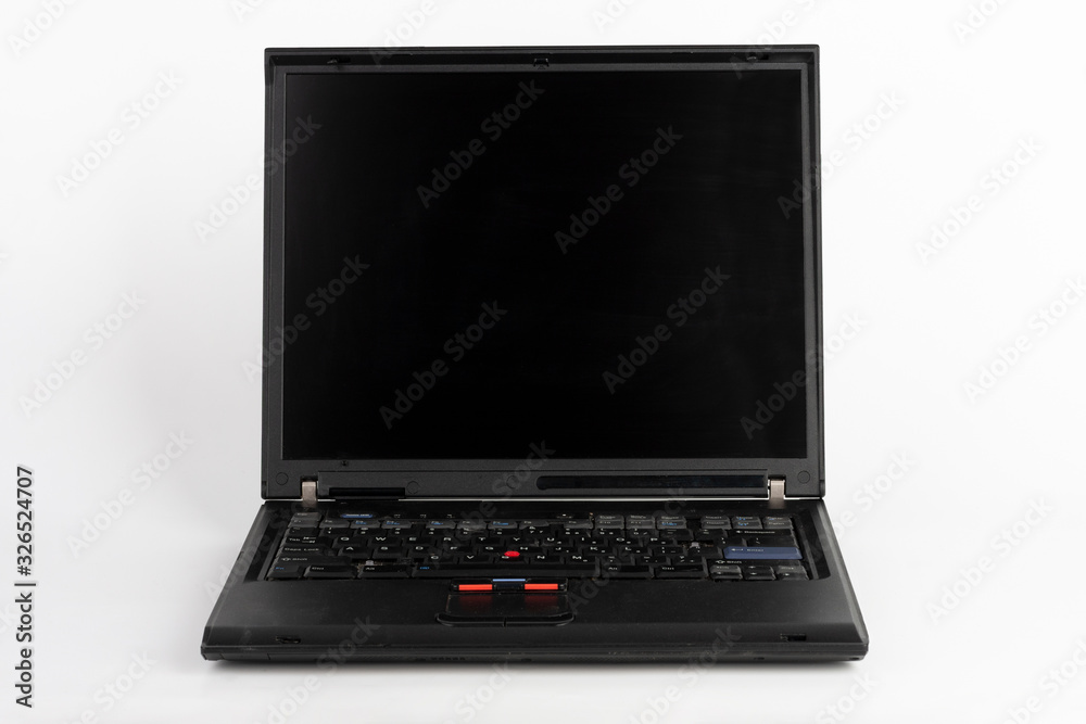 Old laptop on white background, which was produced in 2005, outer cover reinforced titanium, metal hinges, red trackpoint. Old laptop on white background, which was produced in 2005, outer cover reinforced titanium, metal hinges, red trackpoint.