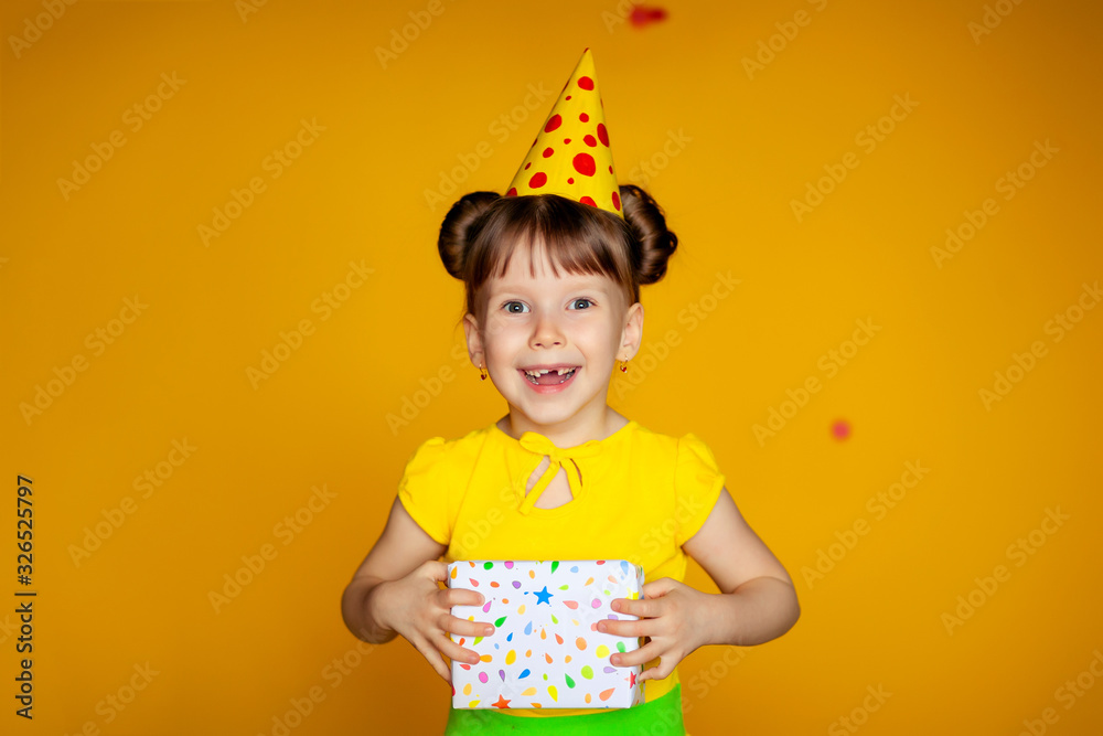 happy birthday happy girl with confetti on color yellow background happy birthday happy girl with confetti on color yellow background