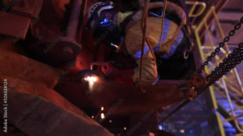 Footage of rope access industrial technician fitters, boilermaker