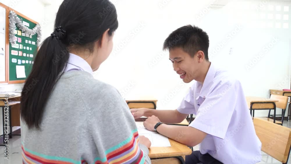 Two Asian students university doing homework, studying workshop together for project in classroom, Academic young teenage team discussion write homework course learn in class for helping each other 4K Two Asian students university doing homework, studying workshop together for project in classroom, Academic young teenage team discussion write homework course learn in class for helping each other 4K